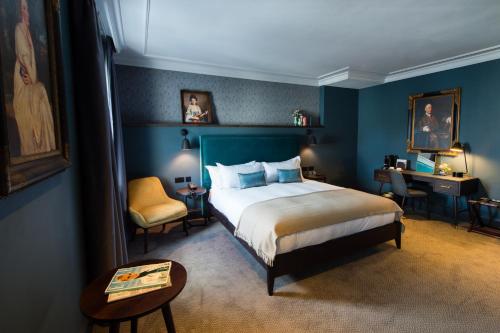 a bedroom with a bed and a table and a chair at Avon Gorge by Hotel du Vin in Bristol