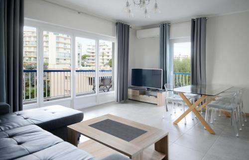 uma sala de estar com um sofá e uma mesa em 2BDR Reine Astrid em Cannes