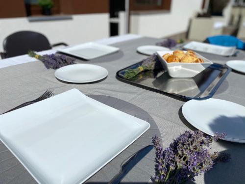 a table with plates and a tray of food on it at Boutique Hotel & Event Center in Budapest