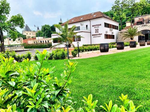 a green lawn in front of a building at Boutique Hotel & Event Center in Budapest