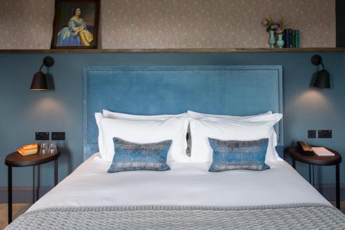 a large bed with a blue headboard and two pillows at Avon Gorge by Hotel du Vin in Bristol