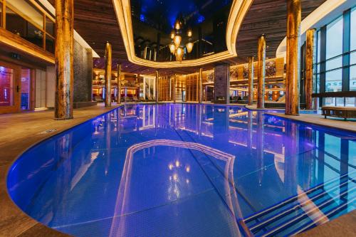 a large swimming pool in a building at Ortner's Resort in Bad Füssing
