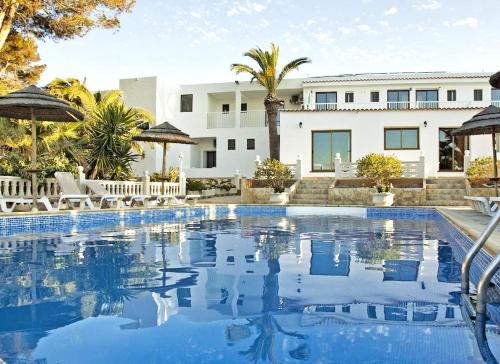a large swimming pool in front of a building at Hotel Lago Dorado - Formentera Break in La Savina