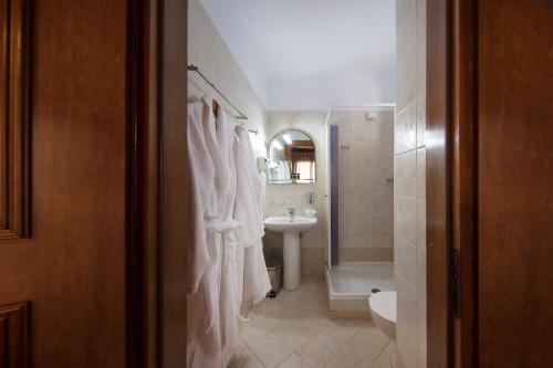 a white bathroom with a sink and a toilet at Spa Guest House by White Hills in the Heart of Arachova in Arachova
