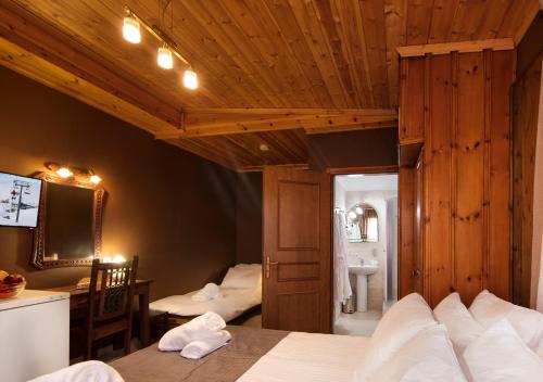 a bedroom with a bed and a mirror and a bathroom at Spa Guest House by White Hills in the Heart of Arachova in Arachova