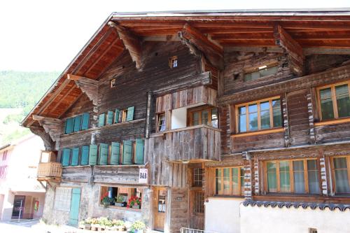 a wooden house in the mountains at B&B La Pivoine in Rossinière