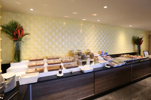 a bakery with a counter with food on it at Transamerica Prestige Recife - Boa Viagem in Recife