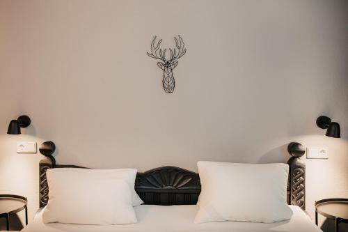 a bedroom with a bed with two white pillows at Flasch Appart-Pension in Wagrain