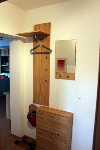 Habitación con tocador de madera y espejo. en Ferienwohnung-Illgen, en Dresden