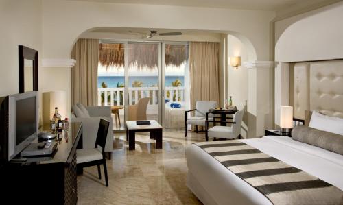 a hotel room with a bed and a view of the ocean at Grand Sunset Princess - All Inclusive in Playa del Carmen