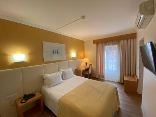 Un pat sau paturi într-o cameră la Hotel Mare