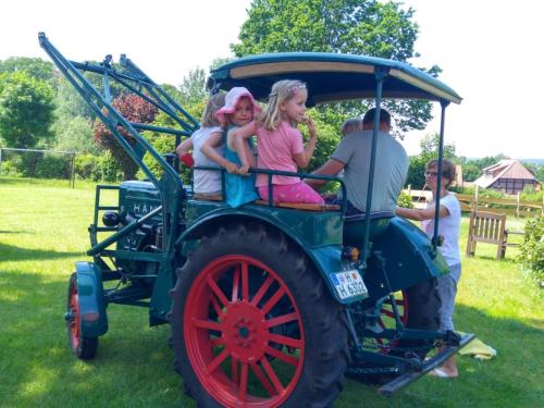 a group of children riding on a tractor at Ferienhof-Heidemann-auch-2-Erwachsene-2-Kinder-moeglich in Neustadt am Rübenberge