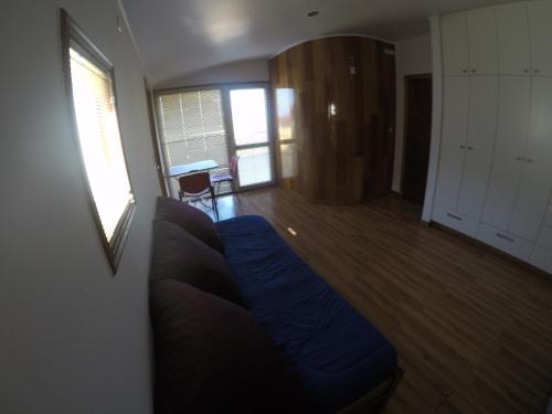 a living room with a blue couch and a table at Lemuria Hostel in Valparaíso