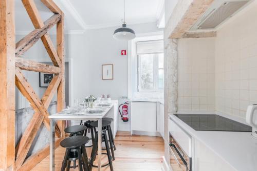 a kitchen with a table and stools in a room at Lisbon Center IV in Lisbon