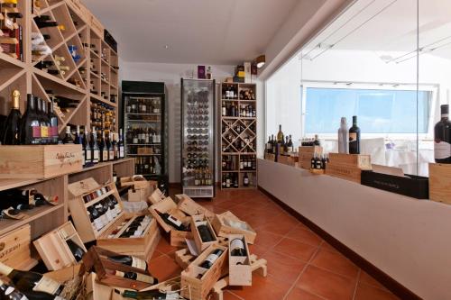 a wine store with a lot of bottles of wine at Hotel Villa Domizia in Porto Santo Stefano