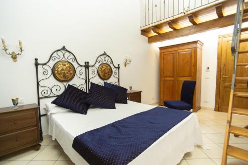 a bedroom with a large bed with a blue comforter at Leano Agriresort in Piazza Armerina