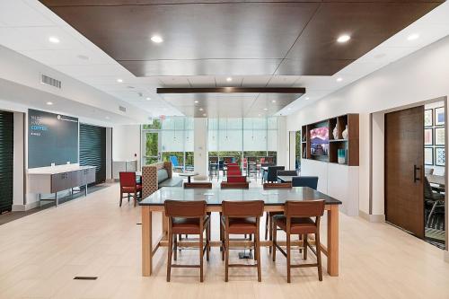 an office lobby with a large table and chairs at Holiday Inn Express - Jacksonville South Bartram Prk by IHG in Jacksonville
