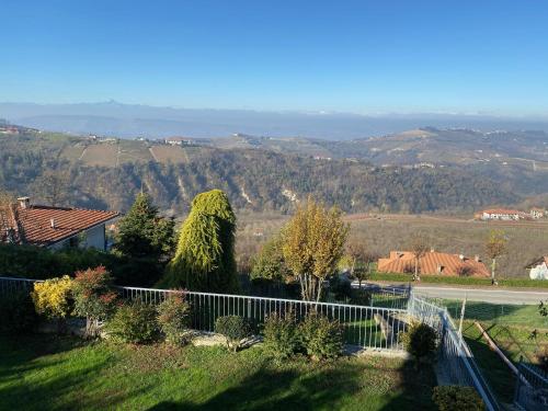 a view of a yard with a fence and trees at LA SISMONDA in Rodello