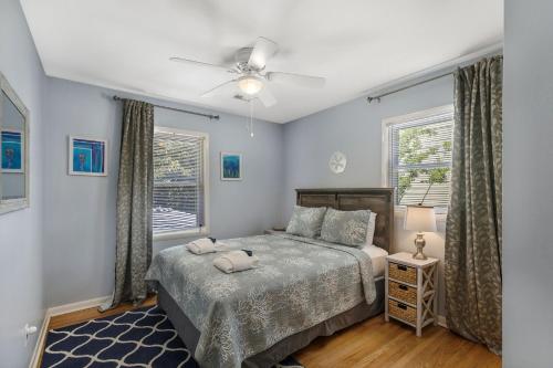 a bedroom with a bed and a ceiling fan at 1010 E Ashley - Two Kitchens - Steps to Beach in Folly Beach