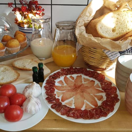 a table with a plate of food with bread and fruit at Casa Olivera- apartament al Passeig Font Vella in Sant Hilari Sacalm