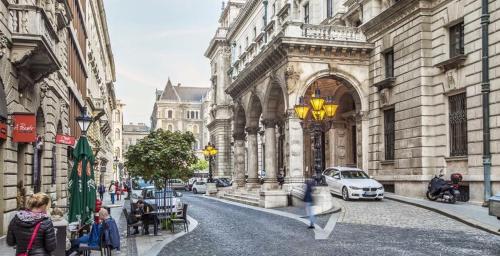 a city street with a car parked in front of a building at Jacuzzi Opera Suite in Budapest
