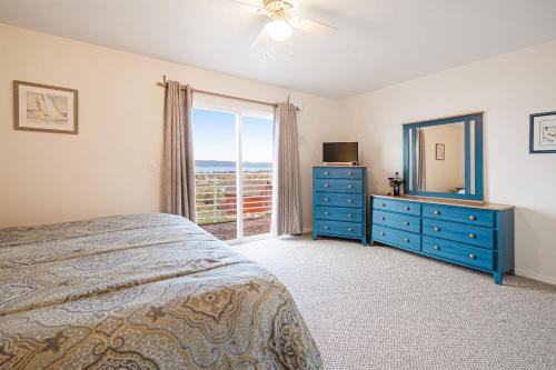 a bedroom with a bed and a dresser and a mirror at Harbor Village Lakeview Condo 902-3 in Garden City