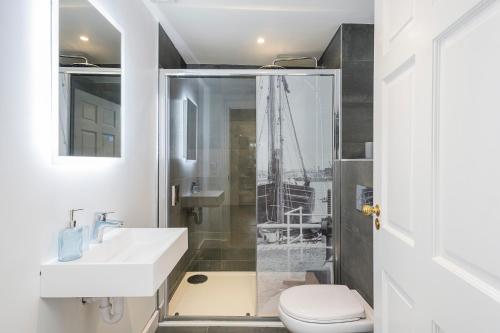 a bathroom with a sink and a toilet and a shower at King Square Serviced Apartments in Bridgwater
