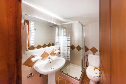 a bathroom with a sink and a toilet at White Apartments by White Hills in Arachova