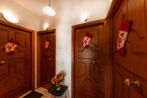 a hallway with wooden doors with christmas socks on them at Luxury Studios & Cozy Apartments by White Hills in Arachova