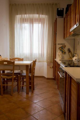 a kitchen with a table and chairs and a window at Le Pinelle in Terni