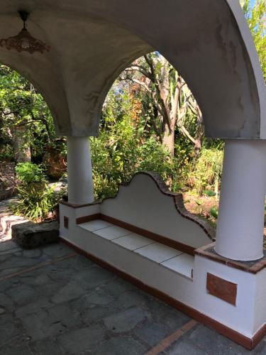 an archway with a bench in a garden at Villa Eva in Anacapri