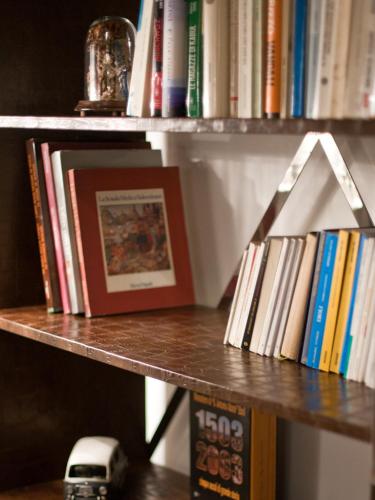 a book shelf with books and a toy truck on it at Hotel Grazia Eboli in Eboli