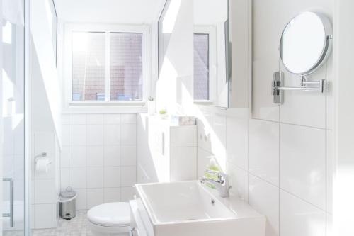 埃肯弗德的住宿－Frau-Clara-Haus-Ecke-4，白色的浴室设有水槽和卫生间。