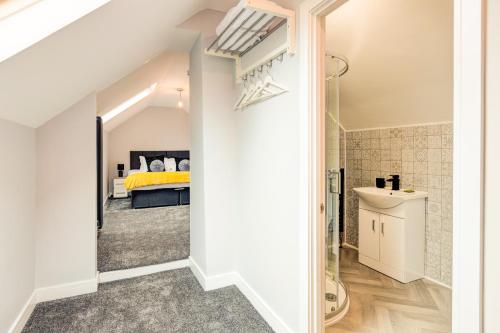 a bedroom with a bed and a bathroom at Bondgate Hotel East Midlands Airport in Castle Donington