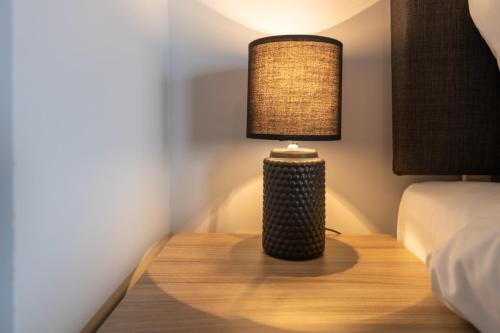 a lamp sitting on a table next to a bed at Bondgate Hotel East Midlands Airport in Castle Donington