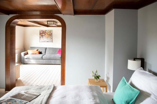 a bedroom with a bed and a couch at Kötterhof Hotel in Herdecke