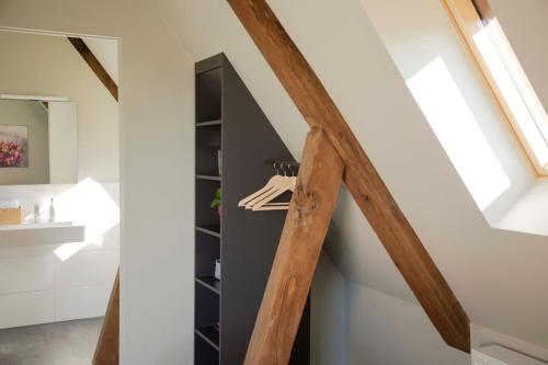 a staircase in a house with wooden beams at Kötterhof Hotel in Herdecke