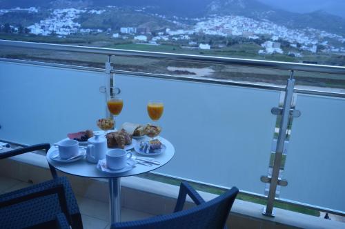 a table with a plate of food on top of a window at Prestige Hotel & Spa in Tetouan
