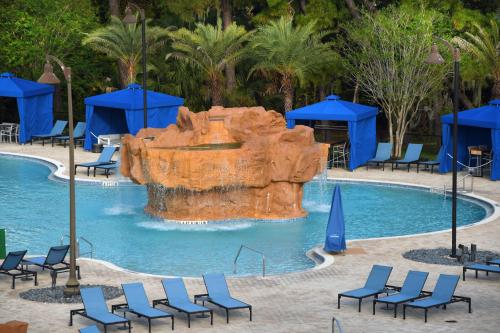 a large pool with a water slide at Wyndham Lake Buena Vista – Disney Springs® Area in Orlando