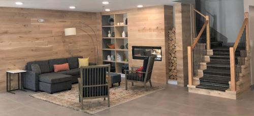 a living room with a couch and a staircase at Country Inn & Suites by Radisson, Stone Mountain, GA in Stone Mountain