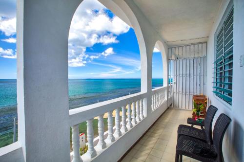 a view from a balcony of a beach with a view of the ocean at Coconut Palms Inn in Rincon
