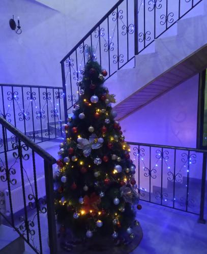 a christmas tree on a staircase in a house at Hotel Elite House in Mestia