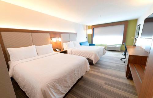 a hotel room with two beds and a desk at Holiday Inn Express & Suites - Kokomo South by IHG in Kokomo