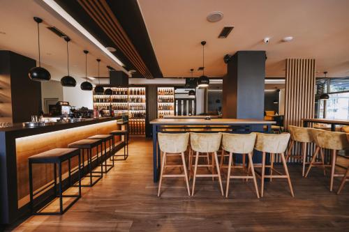 a bar in a restaurant with bar stools at Hotel IN in Banja Luka