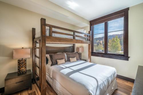 ein Schlafzimmer mit einem Etagenbett und einem Fenster in der Unterkunft Hayden Lodge by Snowmass Mountain Lodging in Snowmass Village