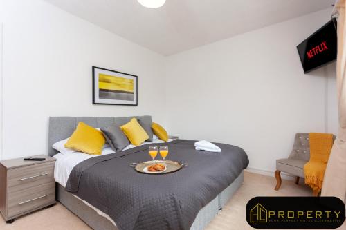 a bedroom with a bed with a tray of food on it at Vale View in Durham