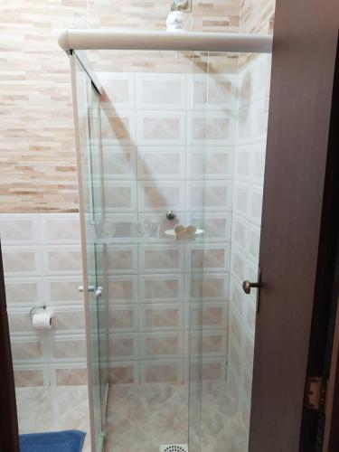 a shower with a glass door in a bathroom at Aeropouso Pousada Executiva in Florianópolis