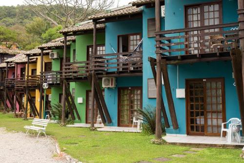a blue building with wooden balconies on it at Chalés Saint Germain in Florianópolis