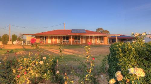a house with solar panels on top of it at Golfers Inn in Tenterfield
