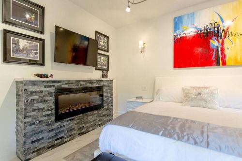 ein Schlafzimmer mit einem Bett und einem Kamin in der Unterkunft Private Luxury Suite with Hot Tub Downtown Eureka Springs in Eureka Springs